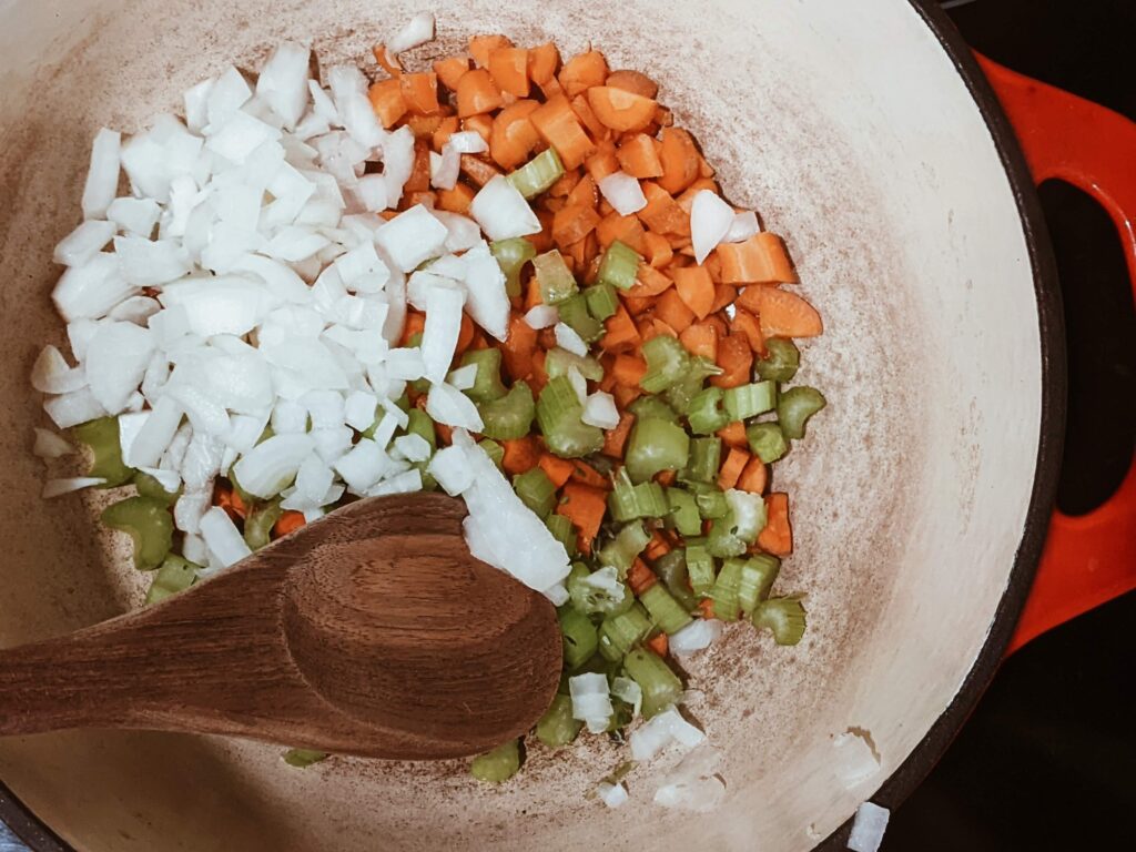 toddler chopping veggies for chicken noodle soup