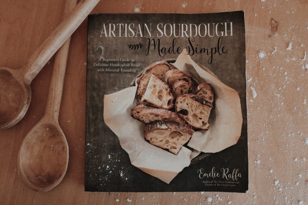 sourdough bread every day cookbook with wooden spoons