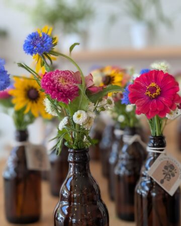 brown jars full of heat loving flowers